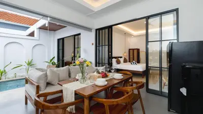 a living room with a table and a couch at Kamila Villa 2 by Villa Finder in Seminyak