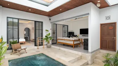 a villa with a pool and a bedroom at Kamila Villa 2 by Villa Finder in Seminyak