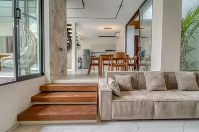 a living room with a couch and a dining room at Nirvana Villa 3BR Brand New in Umalas, Canggu in Kerobokan