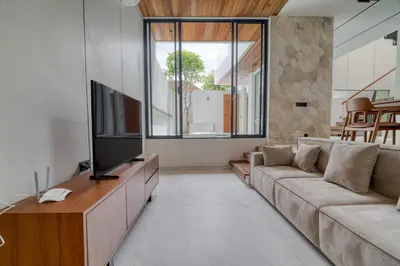 a living room with a couch and a flat screen tv at Nirvana Villa 3BR Brand New in Umalas, Canggu in Kerobokan