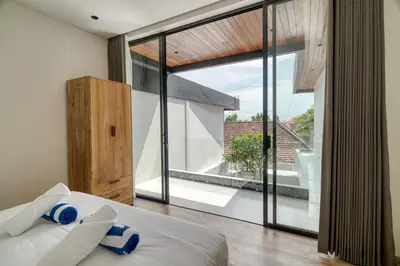 a bedroom with a bed and a large window at Nirvana Villa 3BR Brand New in Umalas, Canggu in Kerobokan
