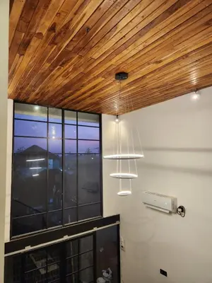 a room with a wooden ceiling and a window at Felly House in Kerobokan