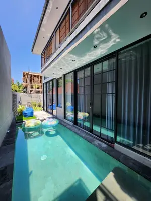a swimming pool in the middle of a house at Felly House in Kerobokan