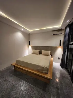 a bedroom with a large bed in a room at Felly House in Kerobokan