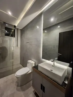 a bathroom with a toilet and a sink and a mirror at Felly House in Kerobokan