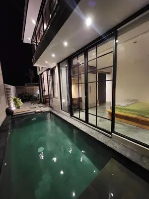 a swimming pool in the middle of a house at Felly House in Kerobokan