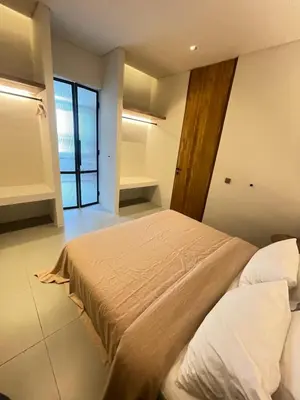 a bedroom with a bed and a large window at Villa Gabrielle in Seminyak