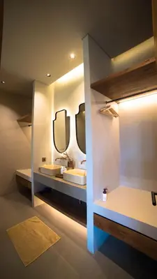 a bathroom with two sinks and two mirrors at Villa Gabrielle in Seminyak
