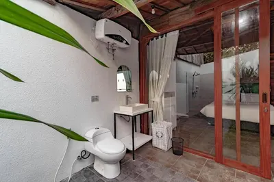 a bathroom with a toilet and a bath tub at Cendani Private Pool Villa Bali in Kuta