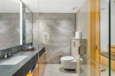 a bathroom with a toilet and a sink at Moriya by Kozystay - Nusa Dua in Nusa Dua
