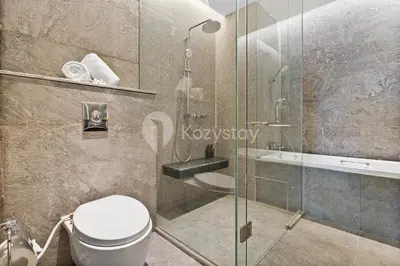 a bathroom with a toilet and a glass shower at Moriya by Kozystay - Nusa Dua in Nusa Dua