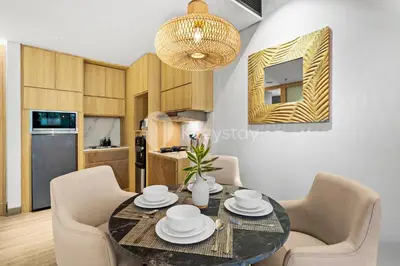 a kitchen and dining room with a table and chairs at Moriya by Kozystay - Nusa Dua in Nusa Dua