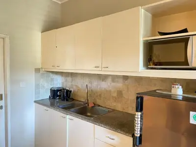 a kitchen with a sink and a microwave at 2bedroom Apartment Petitenget Beach in Seminyak