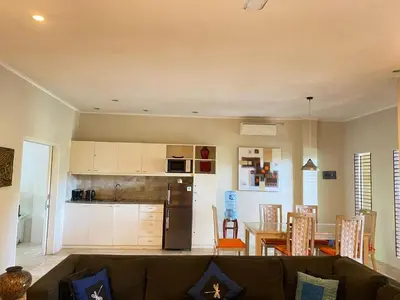 a living room and kitchen with a couch and a table at 2bedroom Apartment Petitenget Beach in Seminyak