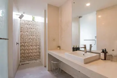 a bathroom with a sink and a mirror at Volare villa in Seminyak