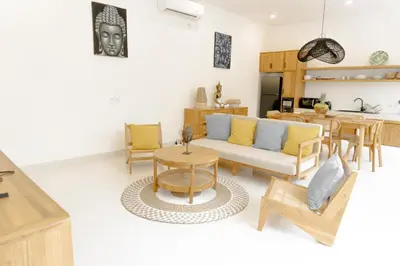 a living room with a couch and a table at Casa Luna Villa in Kerobokan