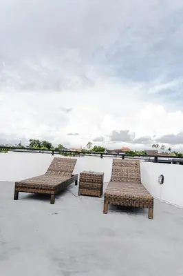two wicker chairs sitting on top of a roof at Casa Luna Villa in Kerobokan