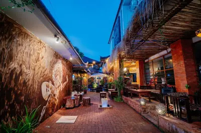 a patio with tables and chairs in a building at The Saharah Mirage Bali in Kuta