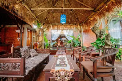a dining room with a long table and chairs at The Saharah Mirage Bali in Kuta