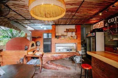 a bar with a large tree stump in a room at The Saharah Mirage Bali in Kuta