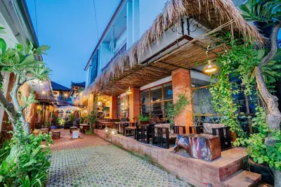a restaurant with tables and chairs outside of a building at The Saharah Mirage Bali in Kuta