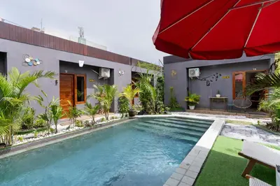 a swimming pool in the backyard of a house at Griya Sadhana Dewi Sri in Legian