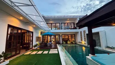 a villa with a swimming pool and a house at Villa Isabella in Seminyak