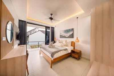 a bedroom with a bed and a large window at Shanti Villa - 3BR Luxury Private Pool Villa in Seminyak in Seminyak