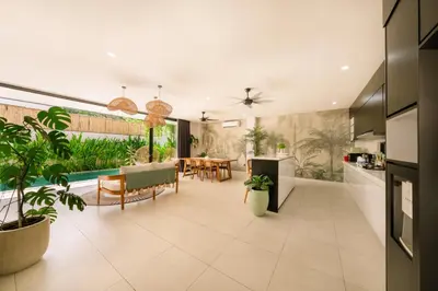 a kitchen and dining room with plants and a dining table at Shanti Villa - 3BR Luxury Private Pool Villa in Seminyak in Seminyak