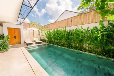 a swimming pool in the backyard of a house at Shanti Villa - 3BR Luxury Private Pool Villa in Seminyak in Seminyak