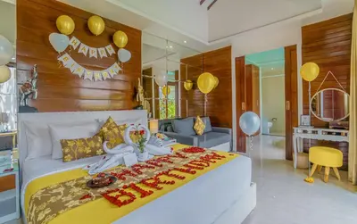 a bedroom with a large bed with balloons on it at Anari Villas Kuta by The Wina Resorts in Legian