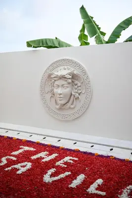 a dollar coin on top of a red rug at The Medusa Villas Bali in Seminyak