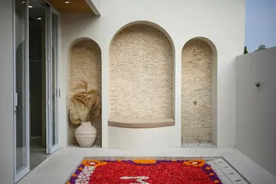 a room with a red flower rug on the floor at The Medusa Villas Bali in Seminyak