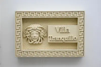 a plaque with a statue of a woman on a wall at The Medusa Villas Bali in Seminyak