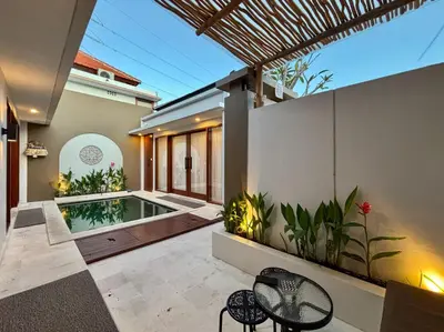 a courtyard with a swimming pool in a house at Solvana Villas Sanur by AGATA in Sanur