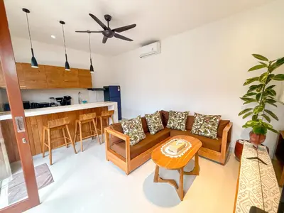 a living room with a couch and a table at The Abian Villa Seminyak in Seminyak