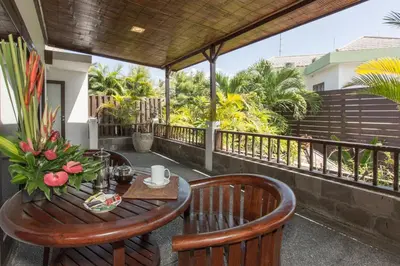 a table and chairs on the balcony of a house at Villa Sedap Malam - Private 2 Bedroom Villa Near Seminyak Beach in Kuta