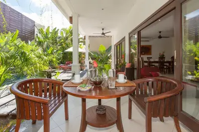 a dining room with a table and two chairs at Villa Sedap Malam - Private 2 Bedroom Villa Near Seminyak Beach in Kuta