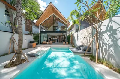an external view of a house with a swimming pool at Villa Bayu by GORO in Canggu
