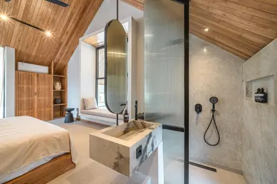 a bedroom with a large mirror and a sink at Villa Bayu by GORO in Canggu