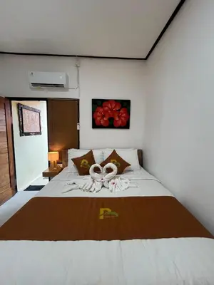 a bedroom with a bed with two rings on it at Pondok Mawar in Badung
