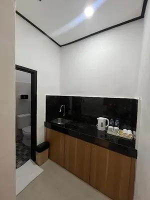 a bathroom with a sink and a toilet at Pondok Mawar in Badung