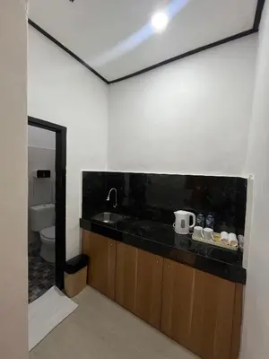 a bathroom with a sink and a toilet at Pondok Mawar in Badung