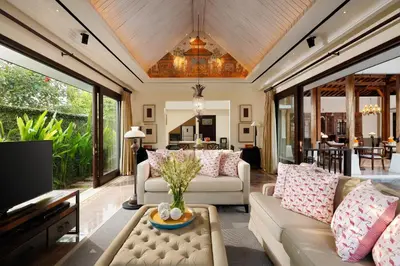 a living room with a couch and a table at Puri Tibo Tanjung Sanur in Sanur
