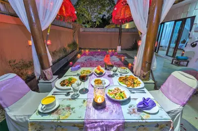 a table with plates of food on it at Private Pool Villas Kuta Bali in Kuta
