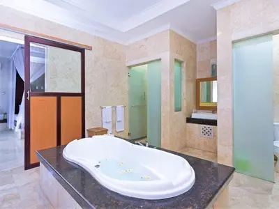 a large bathroom with a large tub on a counter at Private Pool Villas Kuta Bali in Kuta