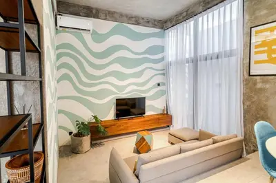 a living room with a couch and a television at Tuju Apartment 1BR Loft in Umalas in Canggu