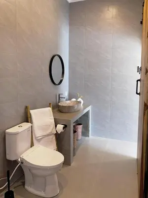 a bathroom with a white toilet and a sink at Kamila Villas 2BR Private Pool Seminyak Central in Seminyak