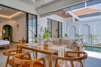 a living room with a table and a couch at Kamila Villas 2BR Private Pool Seminyak Central in Seminyak
