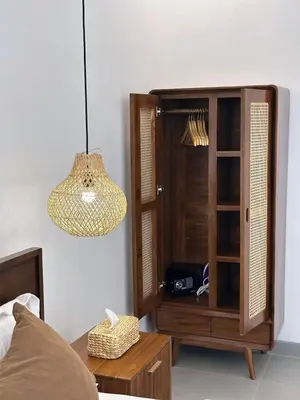 a bedroom with a wooden cabinet and a lamp at Kamila Villas 2BR Private Pool Seminyak Central in Seminyak
